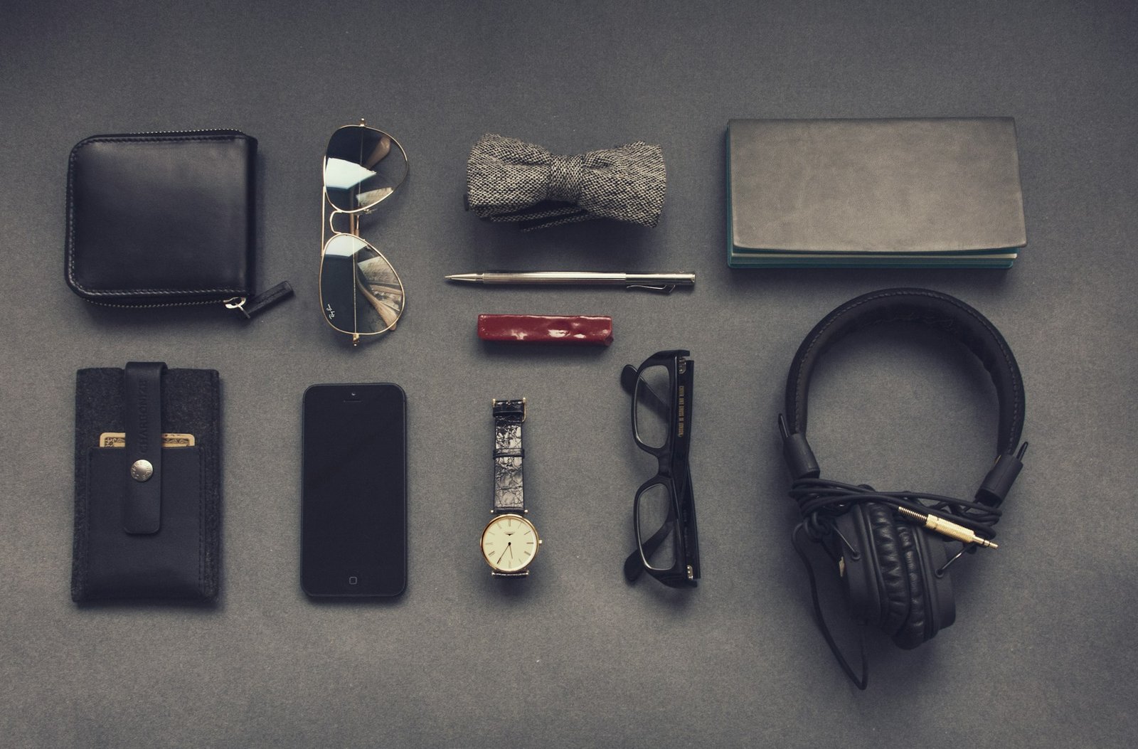 Black corded headphones near eyeglass